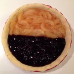 A blueberry and apple pie without its top crust.