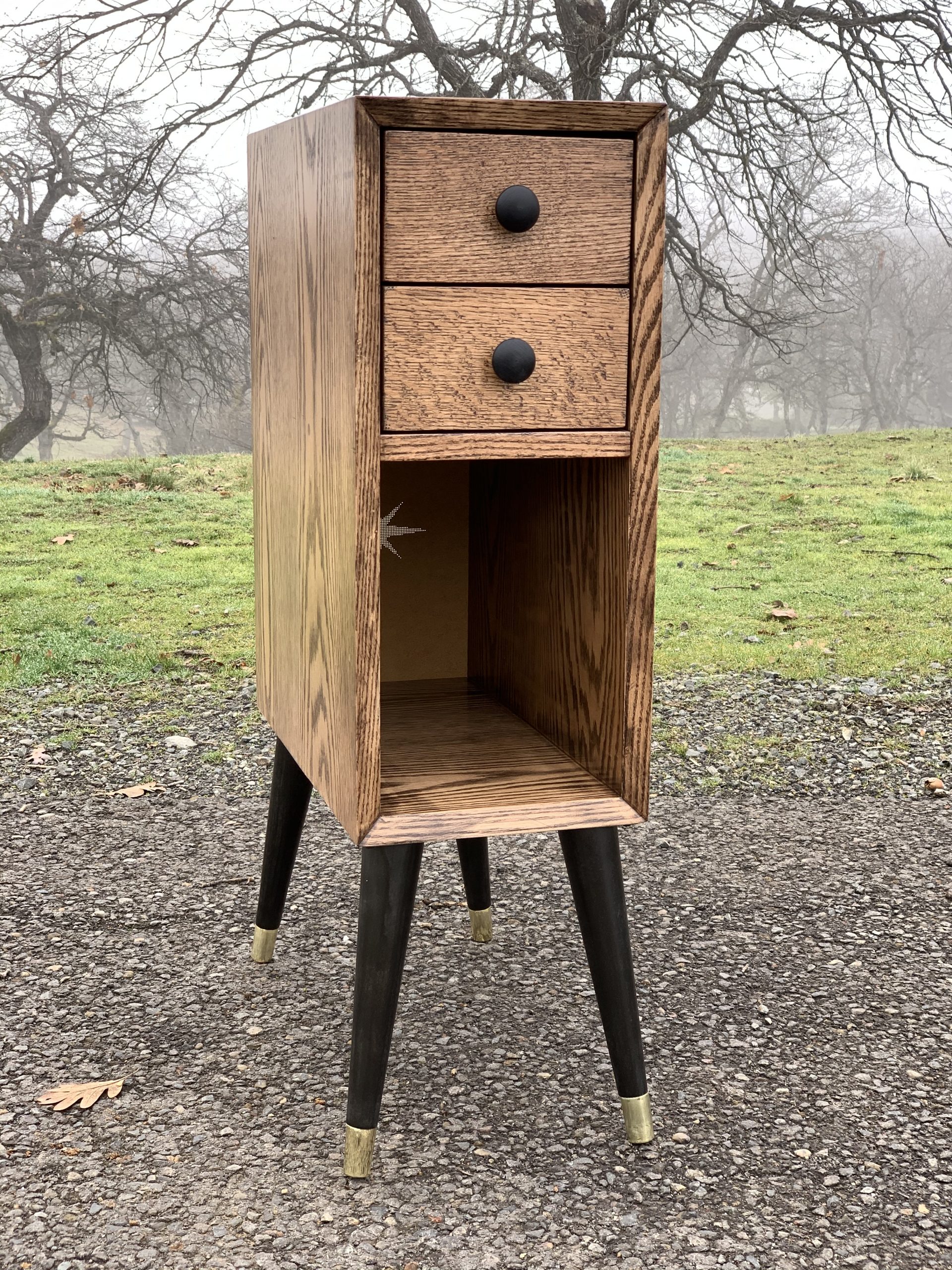 A 31" tall, 9" wide, 18" deep nightstand made of red oak.